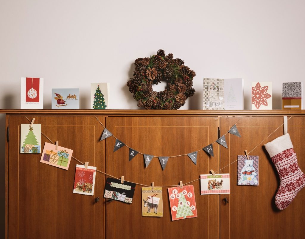Christmas cards on display with holiday decor
