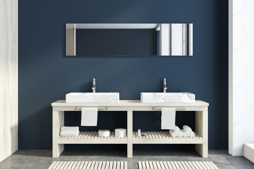 dark blue contemporary bathroom with white double sinks