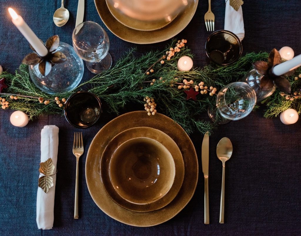 dark dining table with gold and green christmas decor