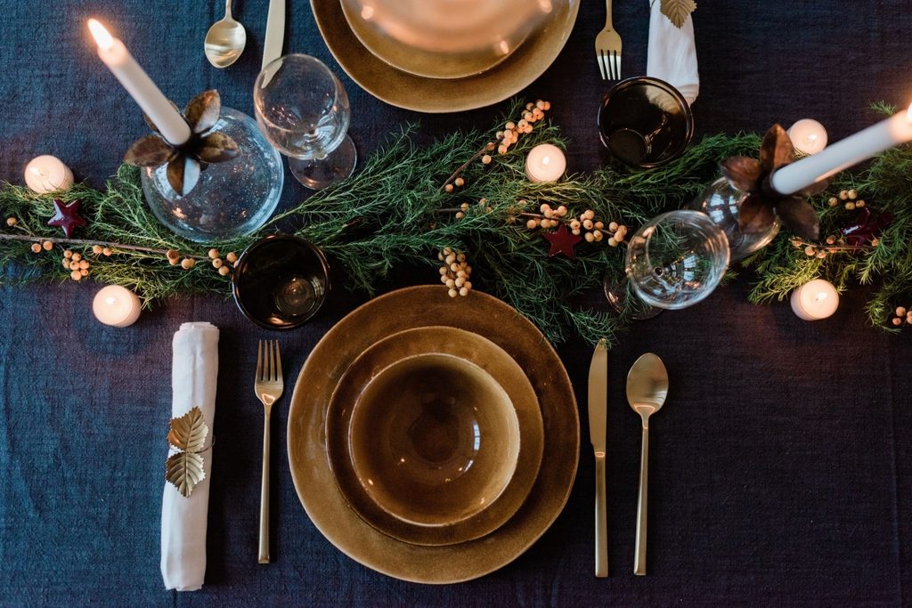 dark dining table with gold and green christmas decor