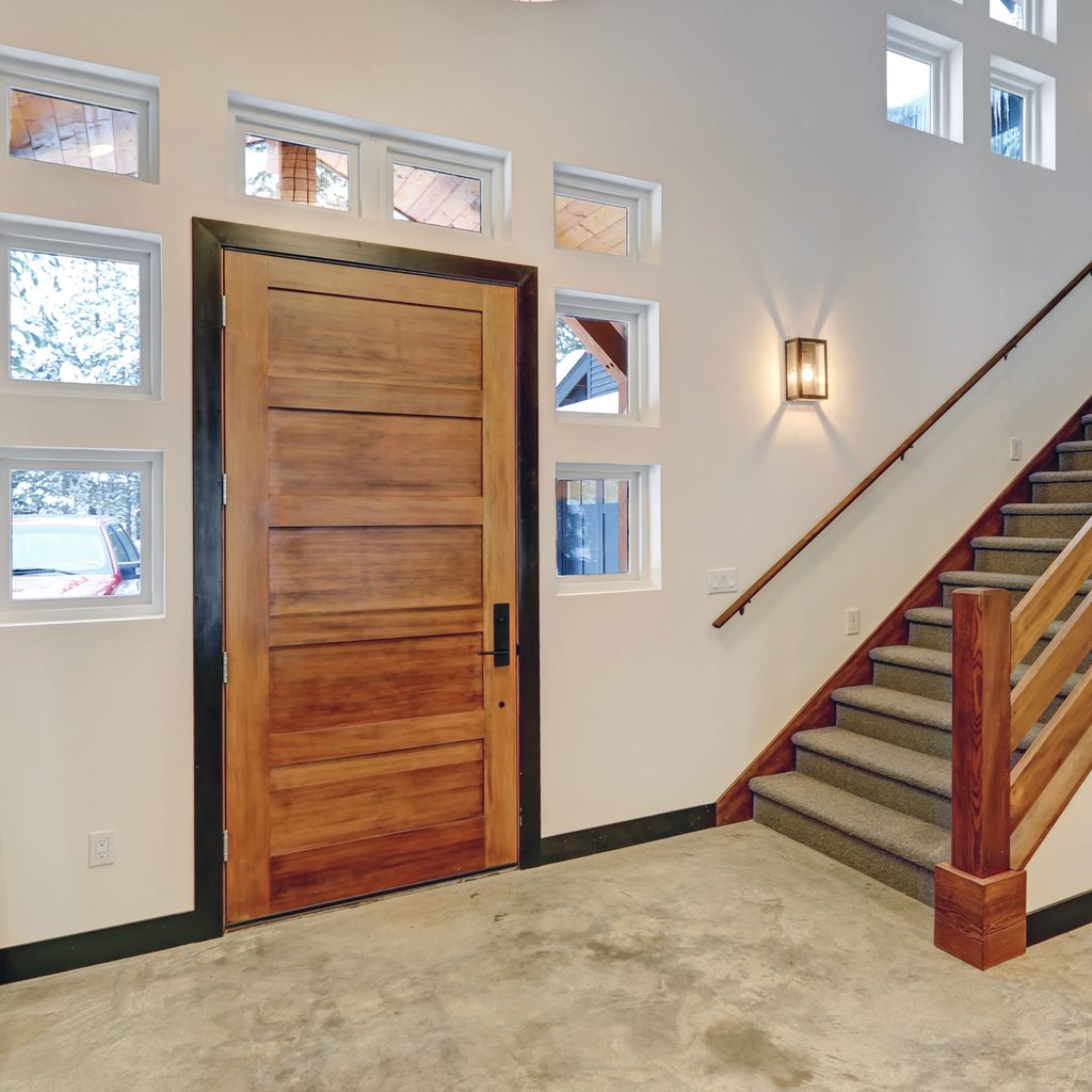 bright entryway with concrete floor and wood accents