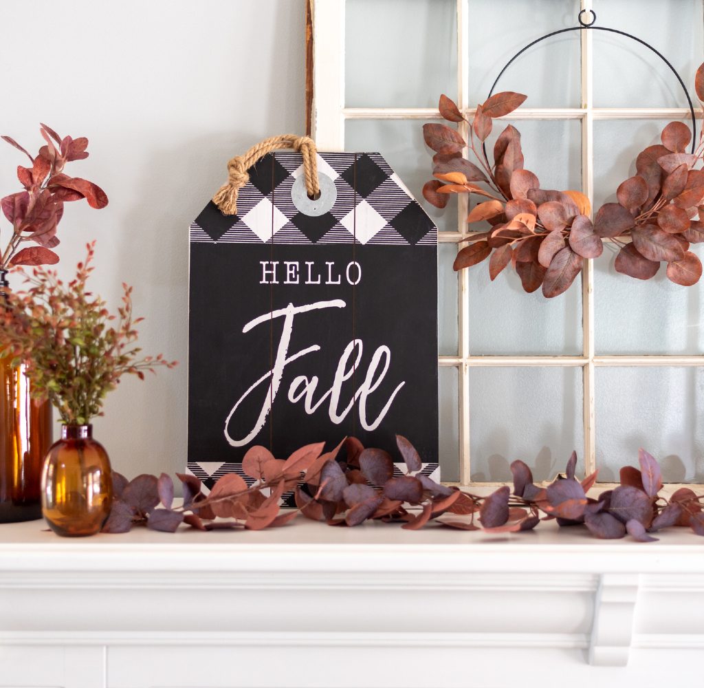 Fall mantle decor leaves and sign.