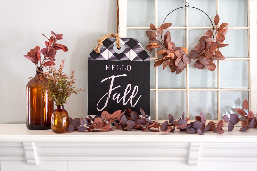 Fall mantle decor leaves and sign.
