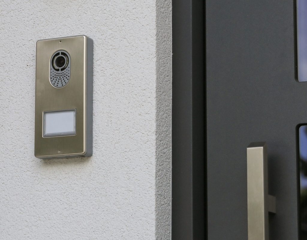 video doorbell beside front door on porch