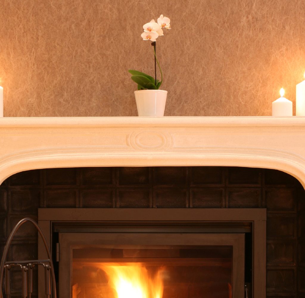 Decluttered mantle with plant.