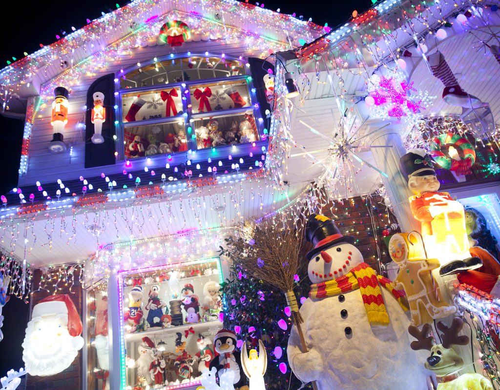 Over-the-top outdoor Christmas decorations on a white house