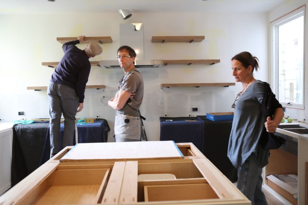 people renovating the kitchen and replacing the cabinets