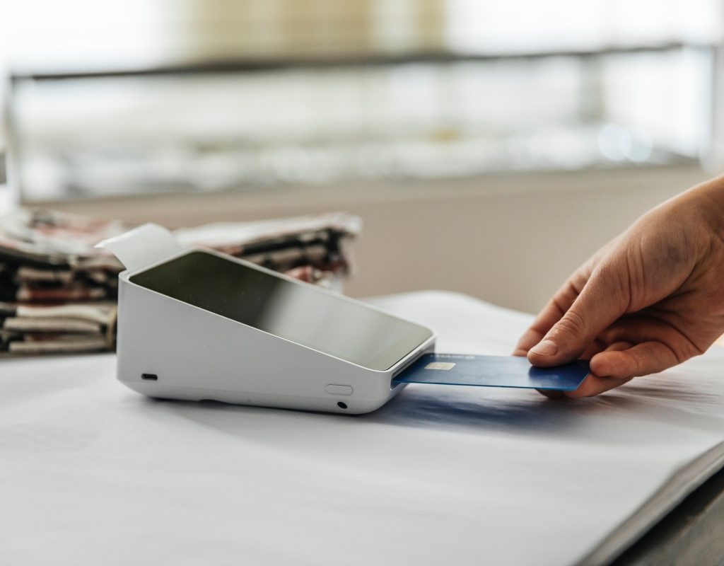 person using a credit card at a store card reader