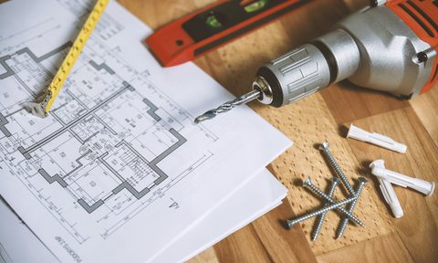 floorplan and tools on wooden surface