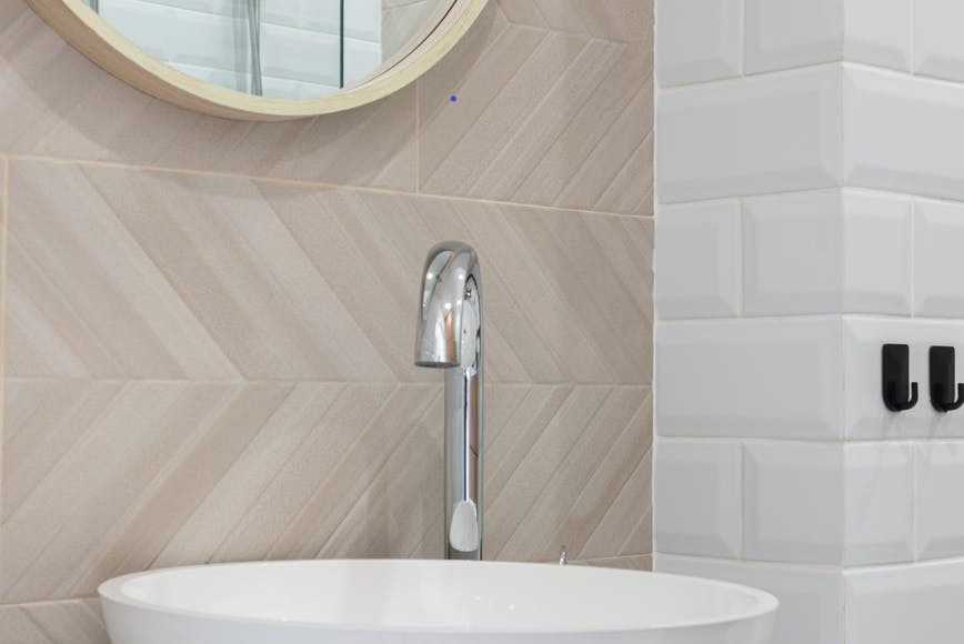 white bathroom sink on counter and mirror