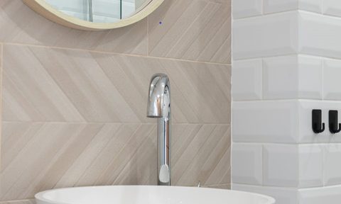 White bathroom sink on counter and mirror