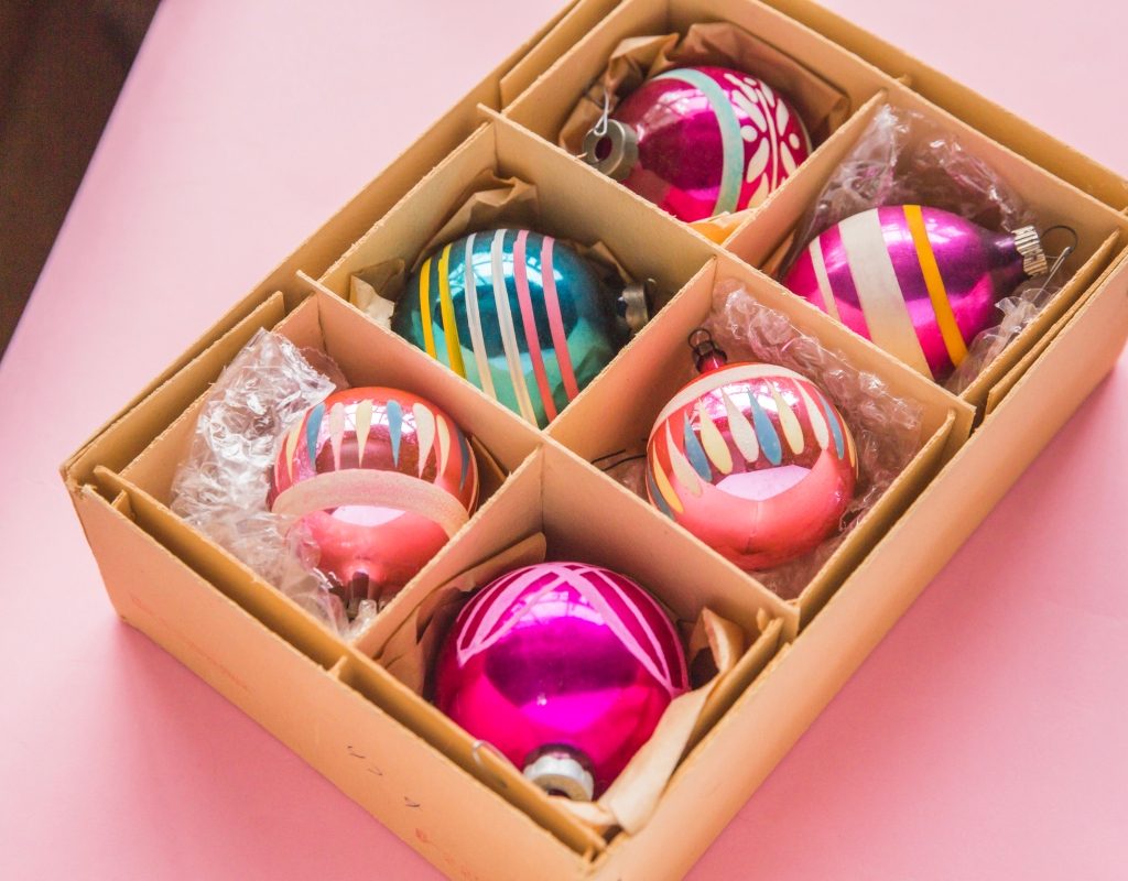 Colorful pink Christmas ornaments in a box
