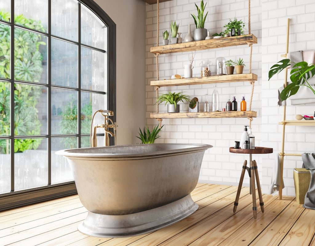 Plants and large window in modern bathroom with large tub