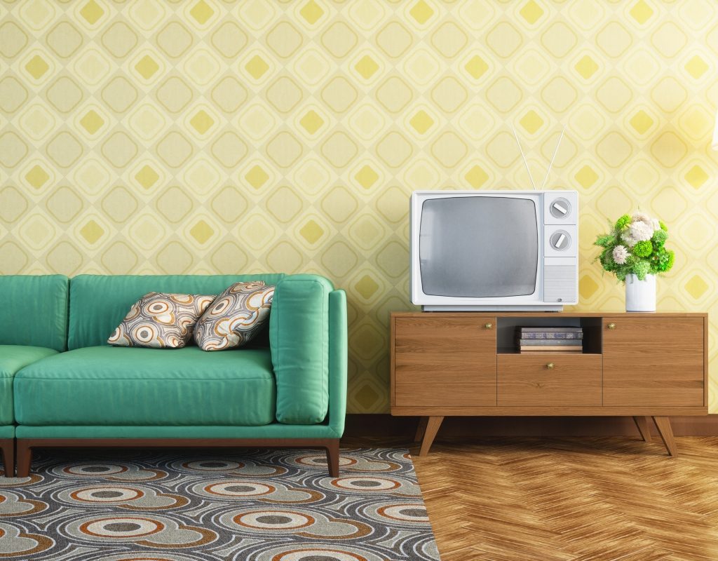 1960's inspired living room with blue couch and yellow walls