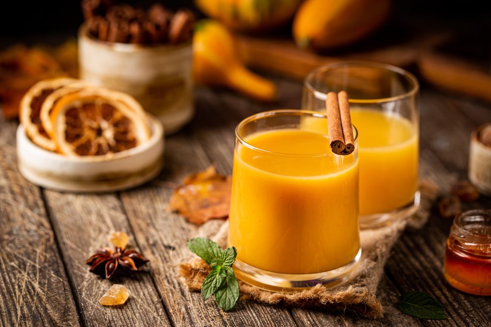 Pumpkin and orange spiced fall cocktail with cinnamon