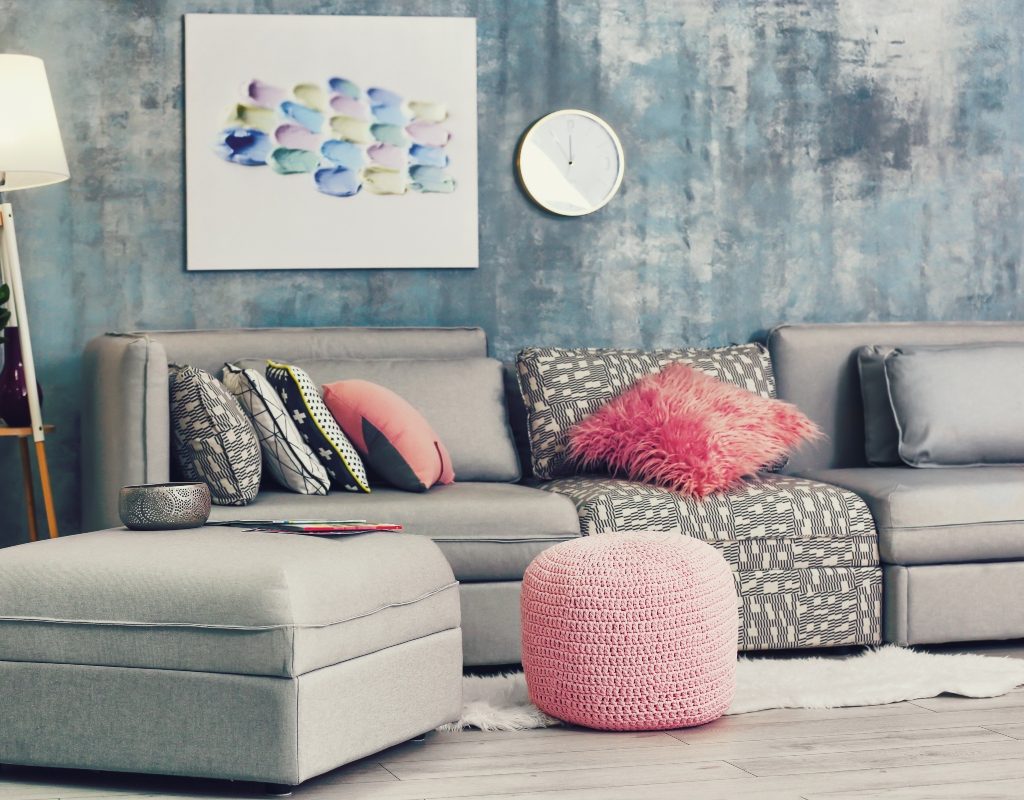 small living room with pink and grey palette and ottoman table
