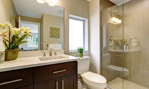 small and beige bathroom with tiny shower