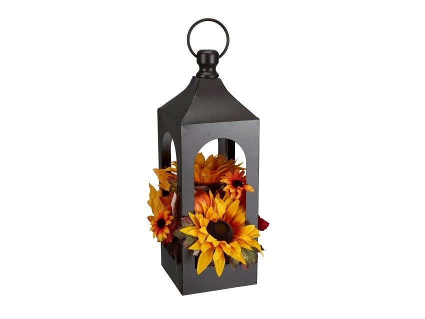 Rustic steel lantern decoration with floral arrangement.