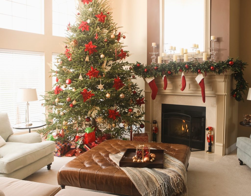 traditional styled christmas decor on fireplace mantle with tree