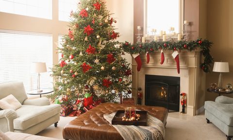 Traditional styled Christmas decor on fireplace mantle with tree