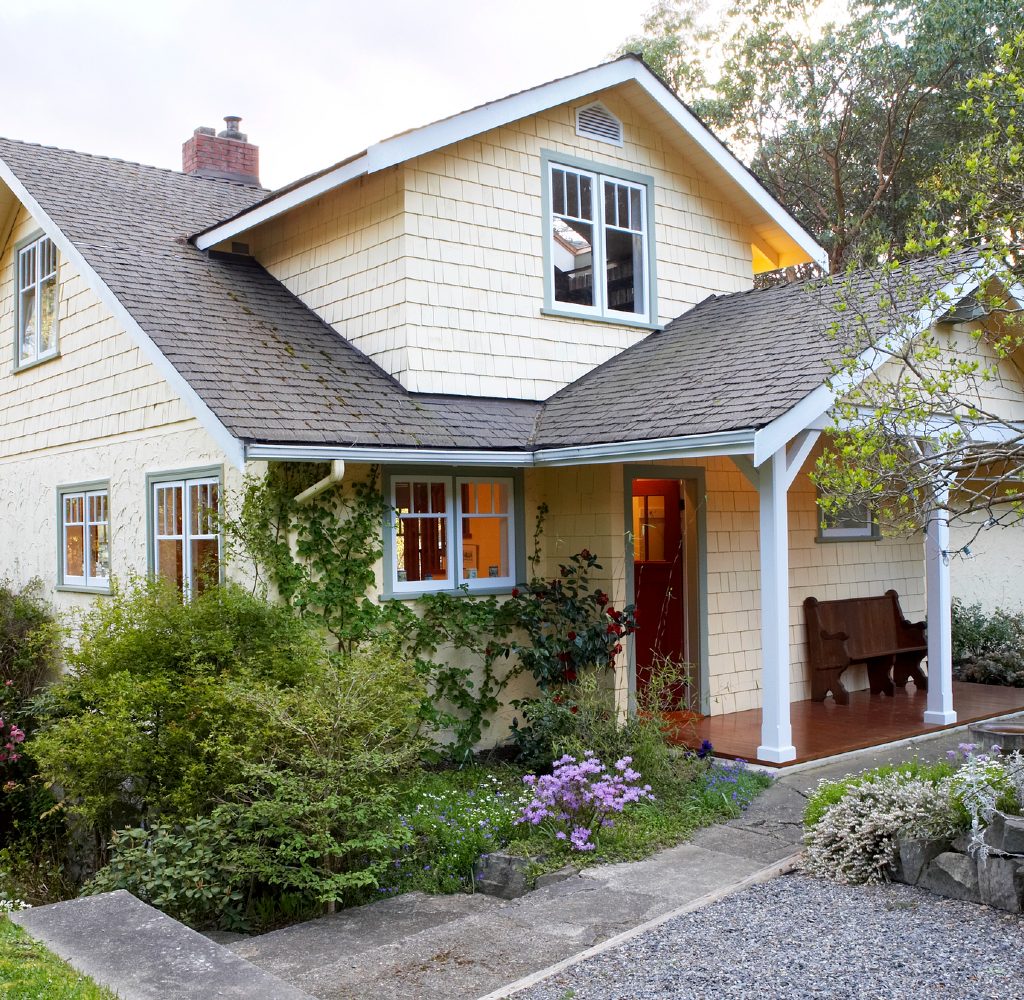 The exterior of a light yellow house