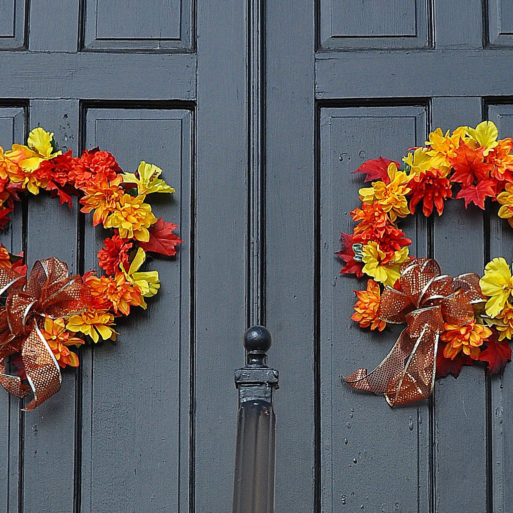Two autumn leaf wreaths on a front door