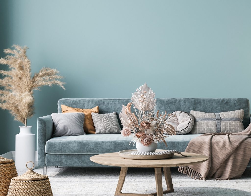 blue velvet couch with woven baskets and blankets for texture