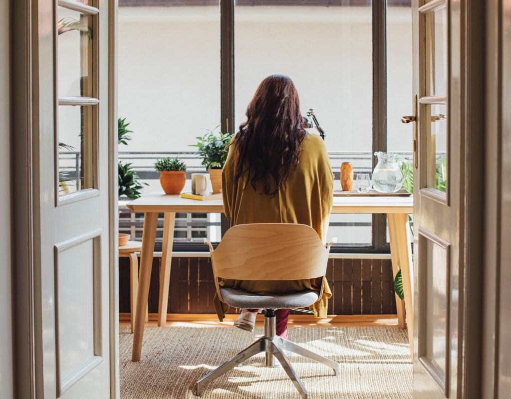 woman sitting at a desk in a mobile office chair