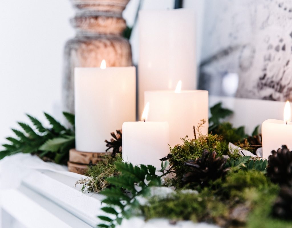 candles and foliage on fireplace mantel
