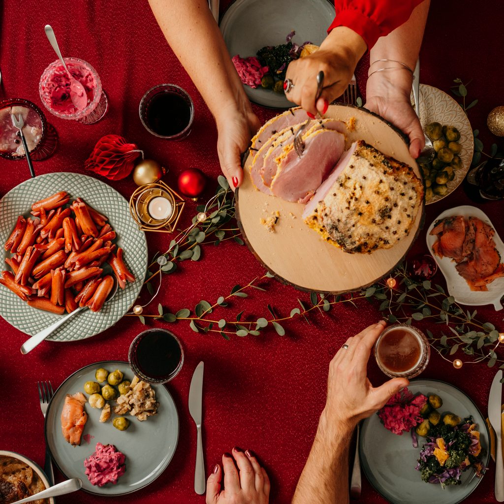 Christmas dinner from above with red table cloth and candles