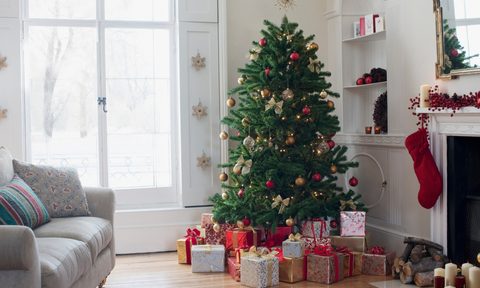 Christmas tree in living room surrounded by presents