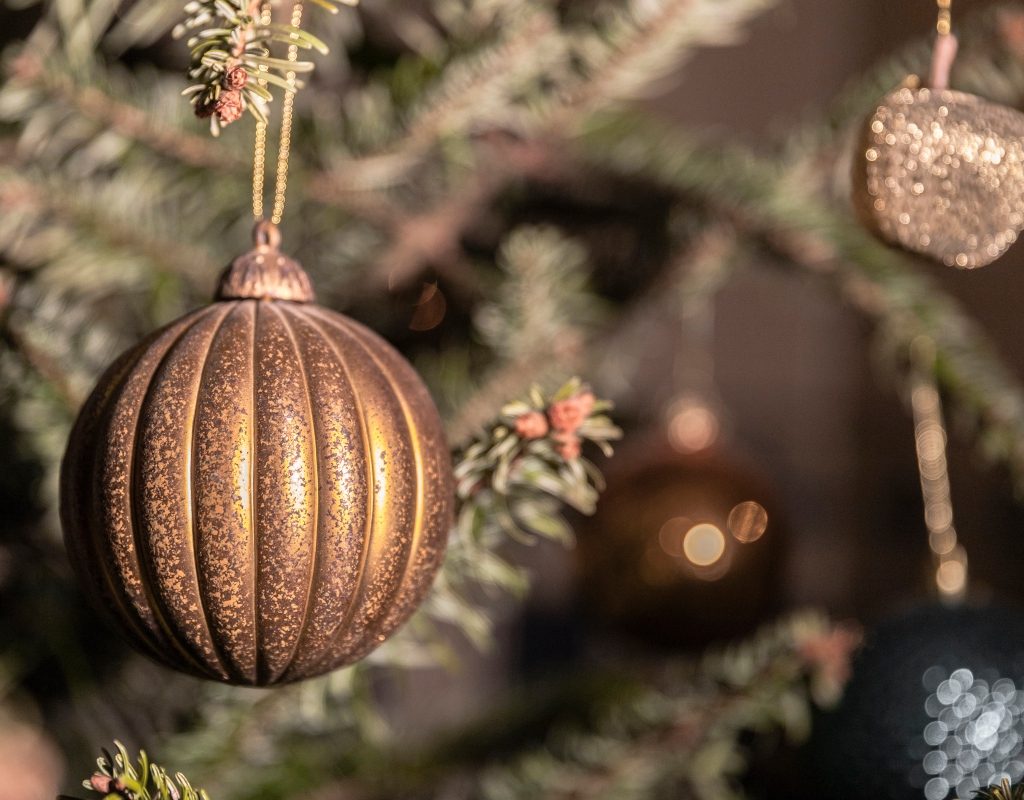 close up view of neutral christmas bulb ornaments on tree