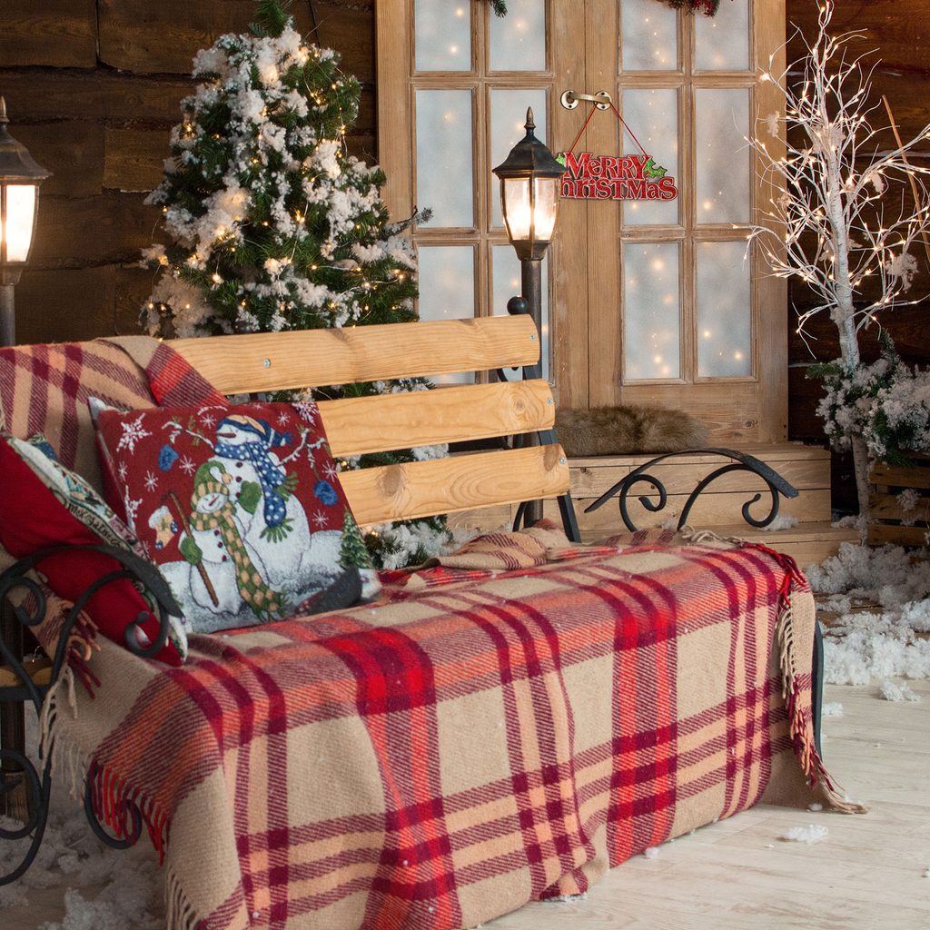 Cozy winter porch bench and decor
