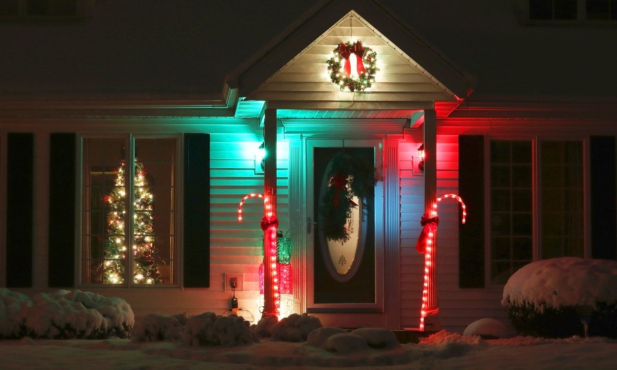 Front yard of home with lit candy canes for Christmas