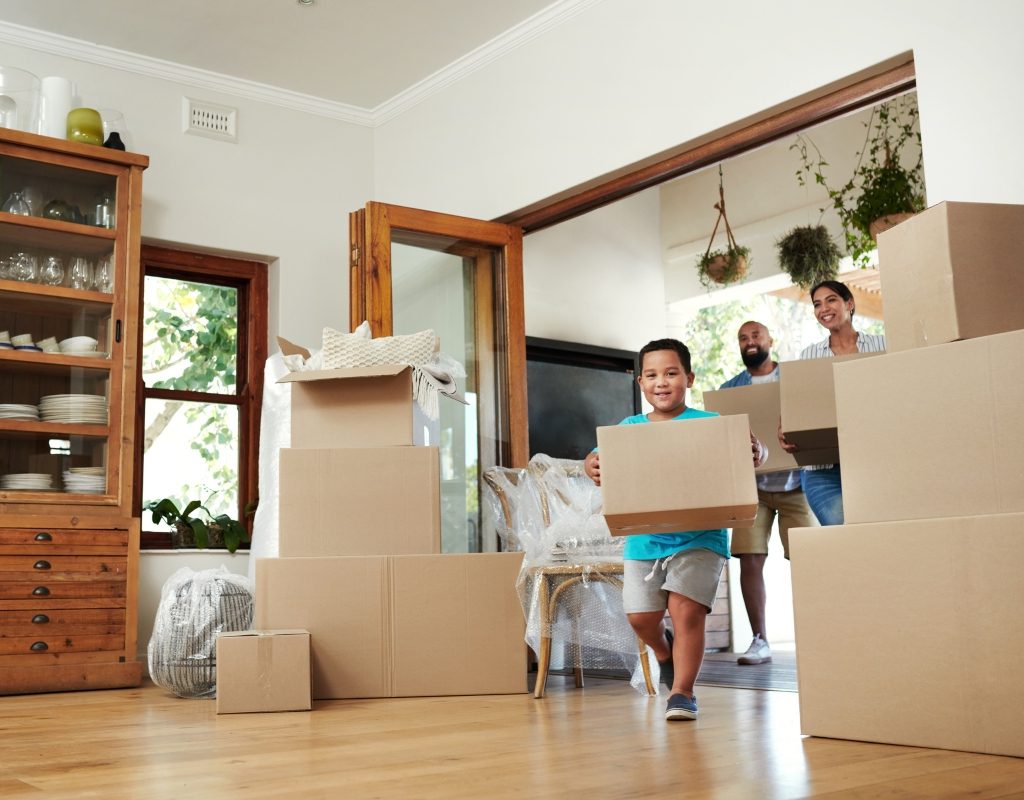 family moving their boxes into their new home