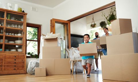 family moving their boxes into their new home