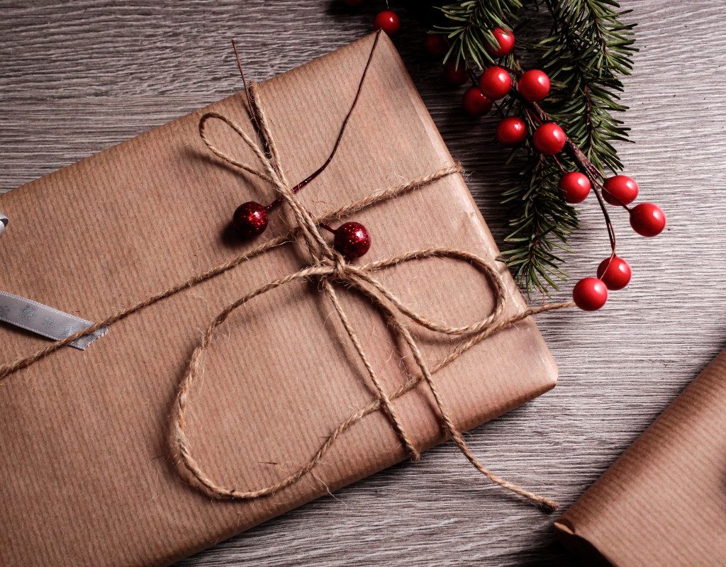 Christmas gift wrapped in brown paper with cranberries