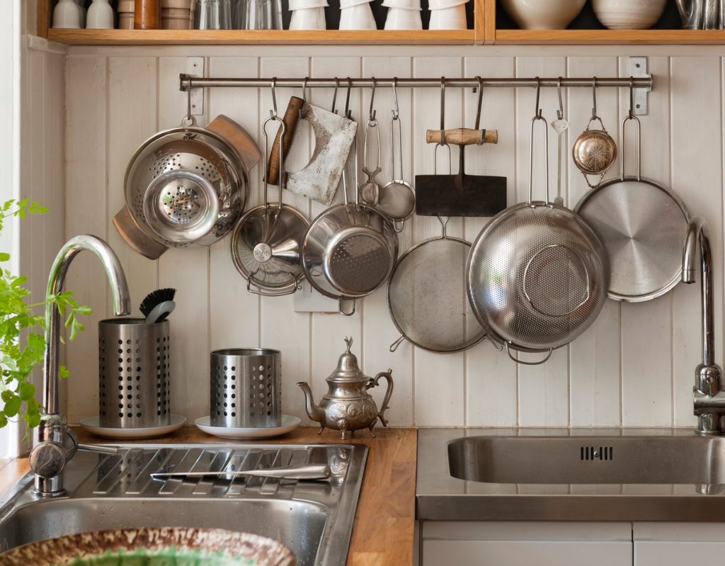 hanging pots and pans above sink in tiny kitchen