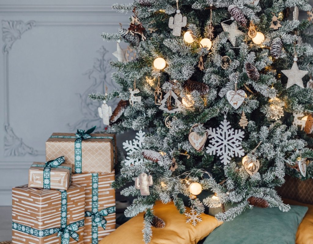 lower view of a snow-dusted rustic christmas tree