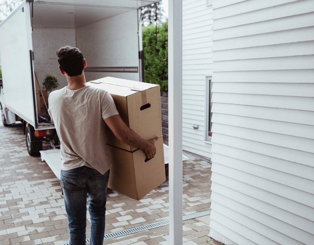 man carrying boxes to a moving truck