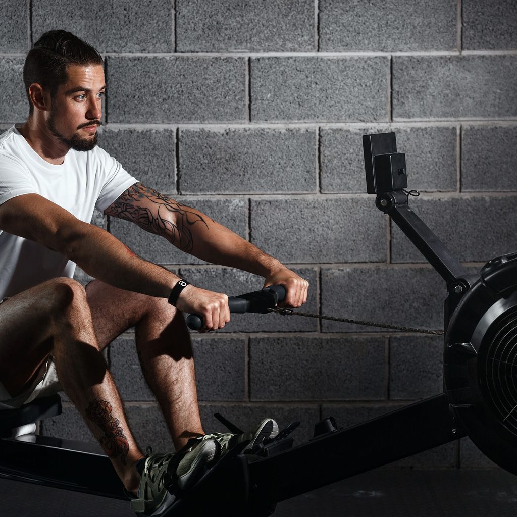 Man working out on a rowing machine