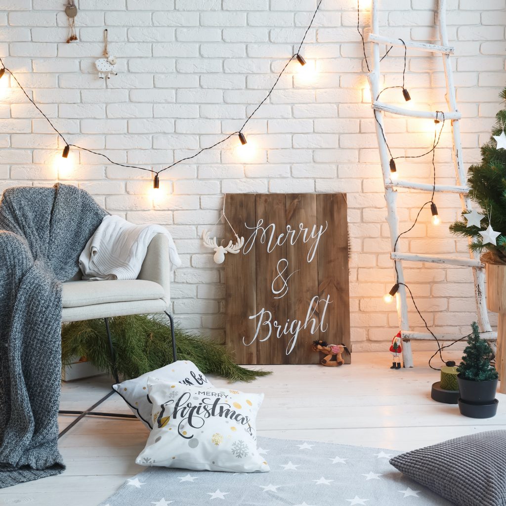 Christmas decorations in house with wall sign on floor