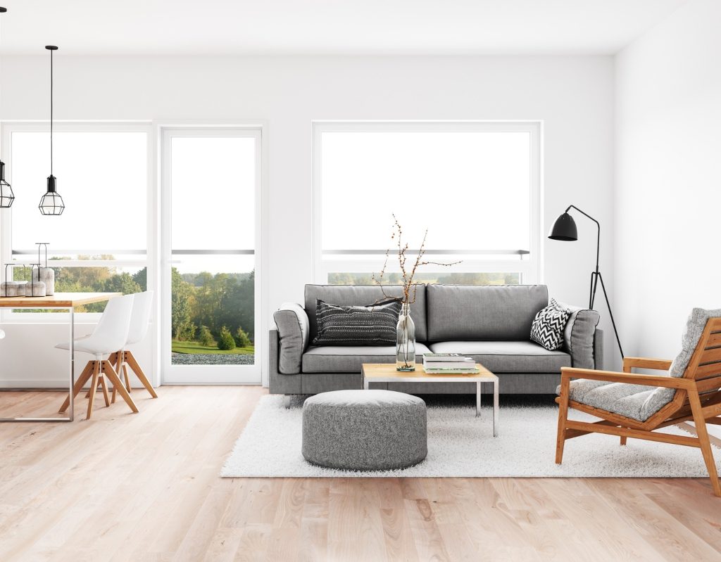 minimalist living room with grey sofa and a wooden chair