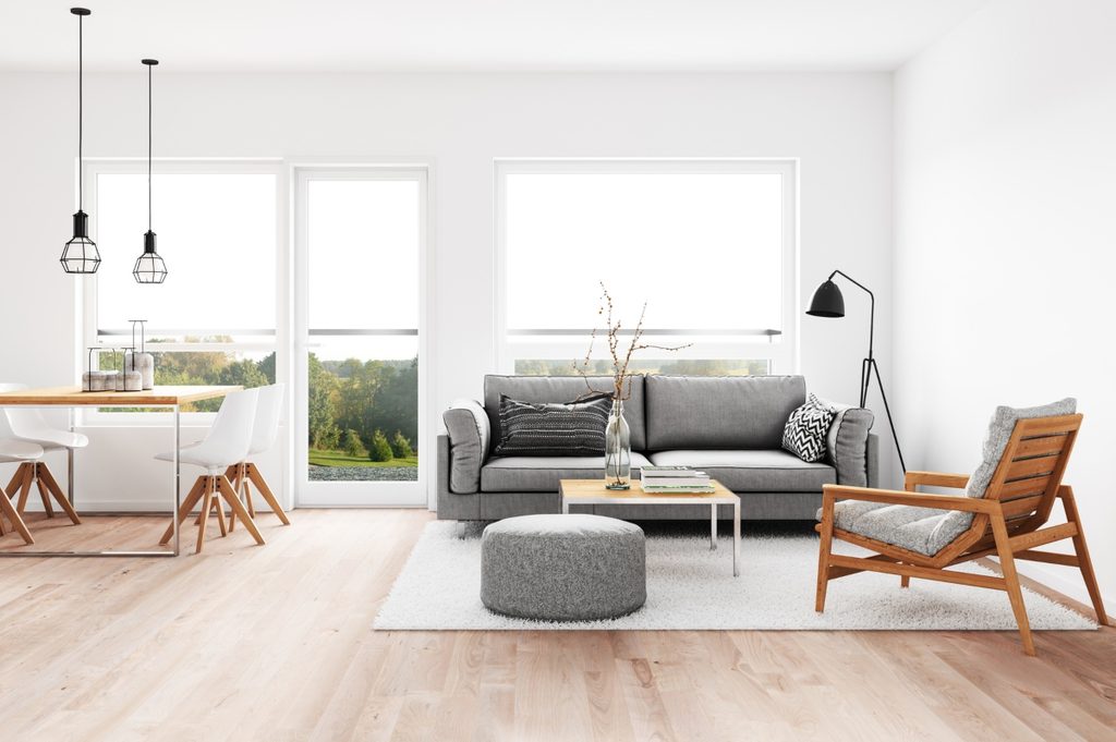 minimalist living room with grey sofa and a wooden chair