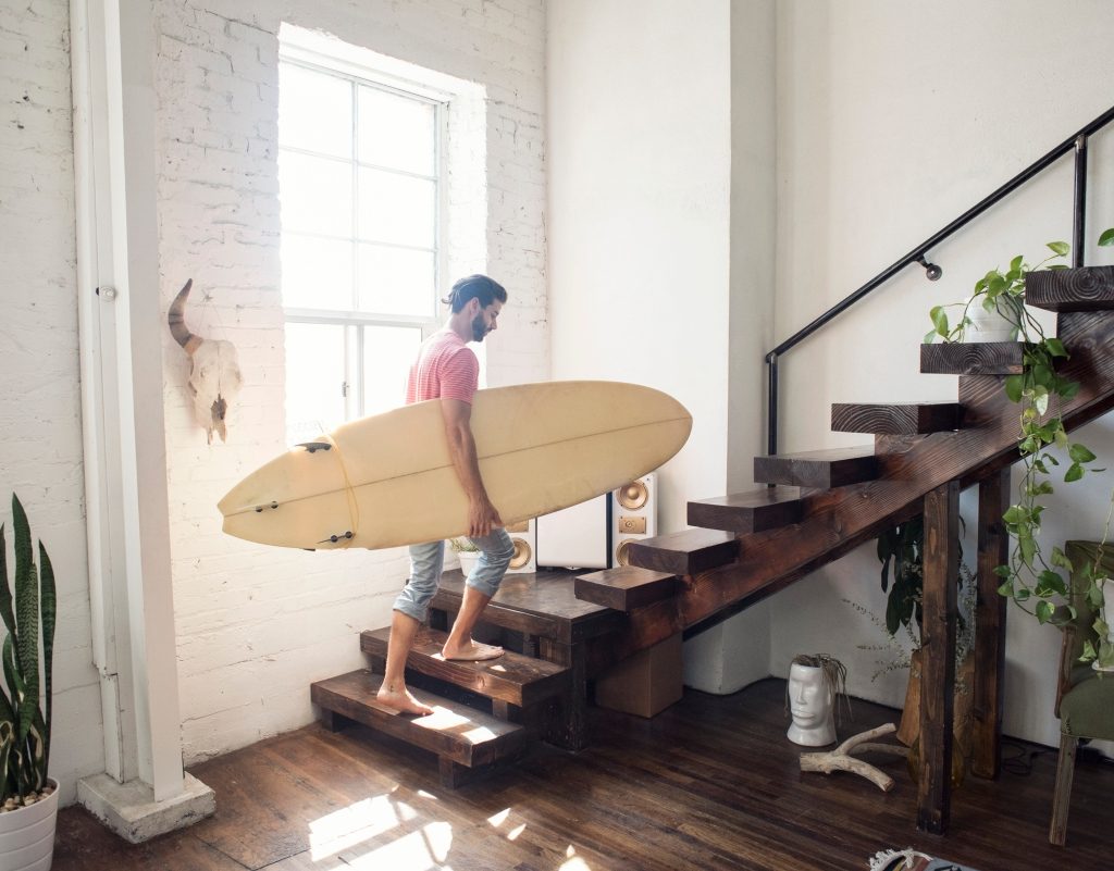 Modern home with man walking up open staircase