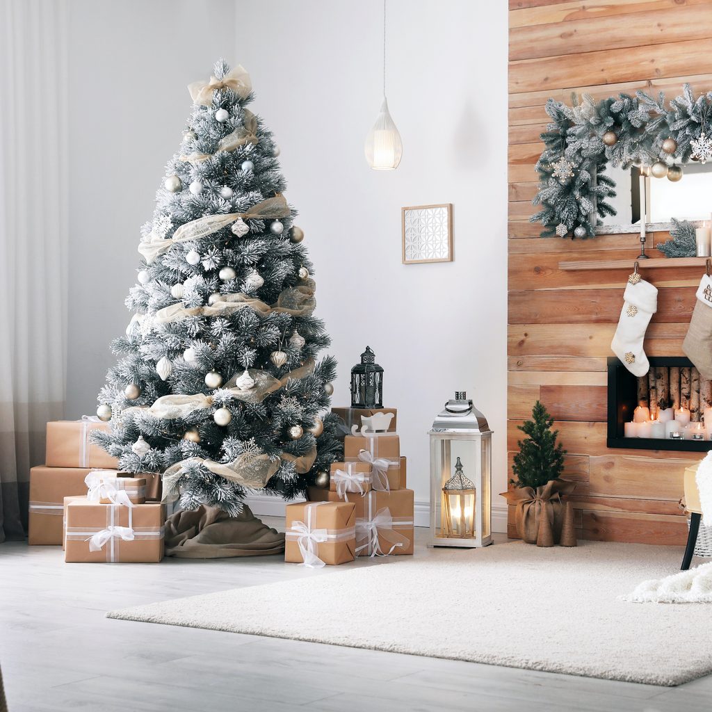 Festive interior with decorated Christmas tree and fireplace