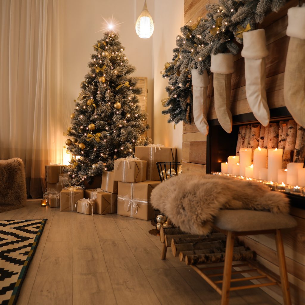 Stylish room interior with beautiful Christmas tree and decorative fireplace