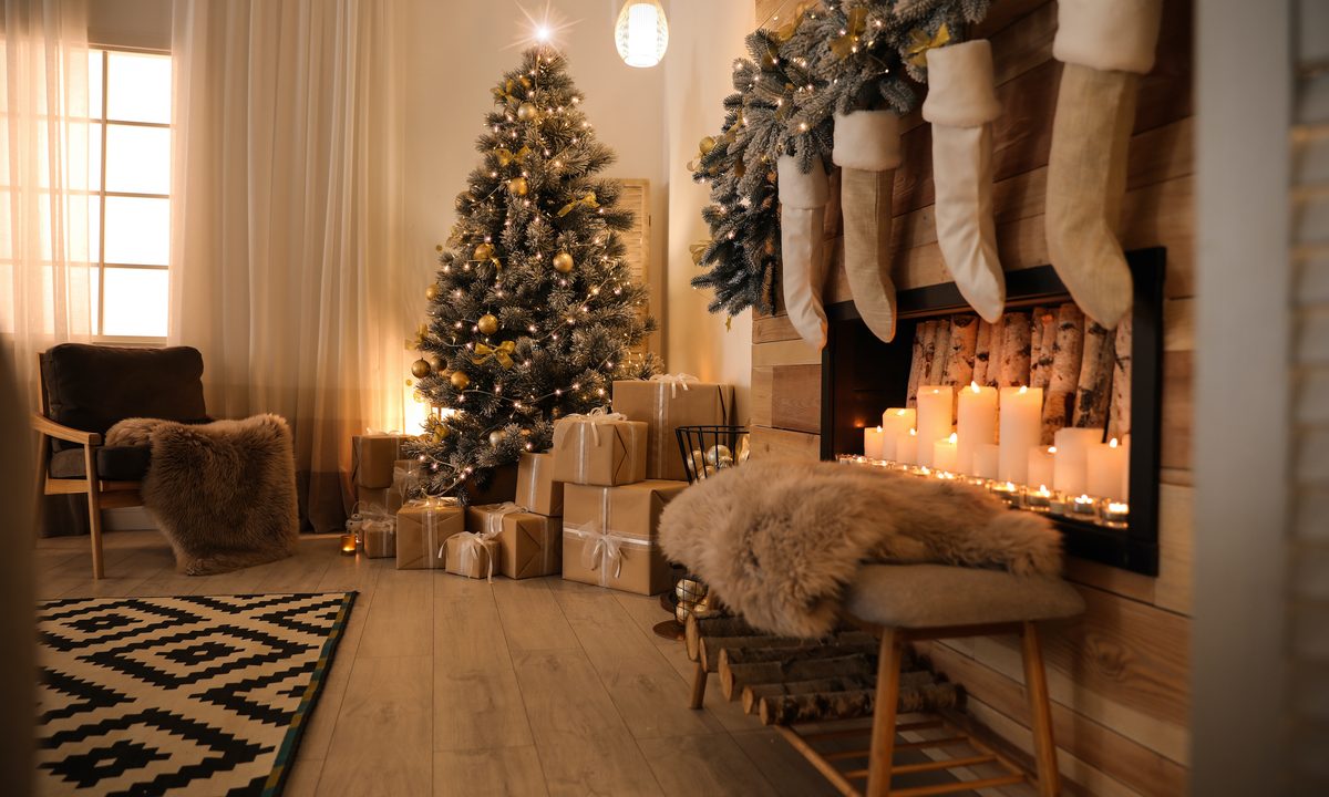 Stylish room interior with beautiful Christmas tree and decorative fireplace