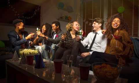 People celebrating New Year's Eve in living room.