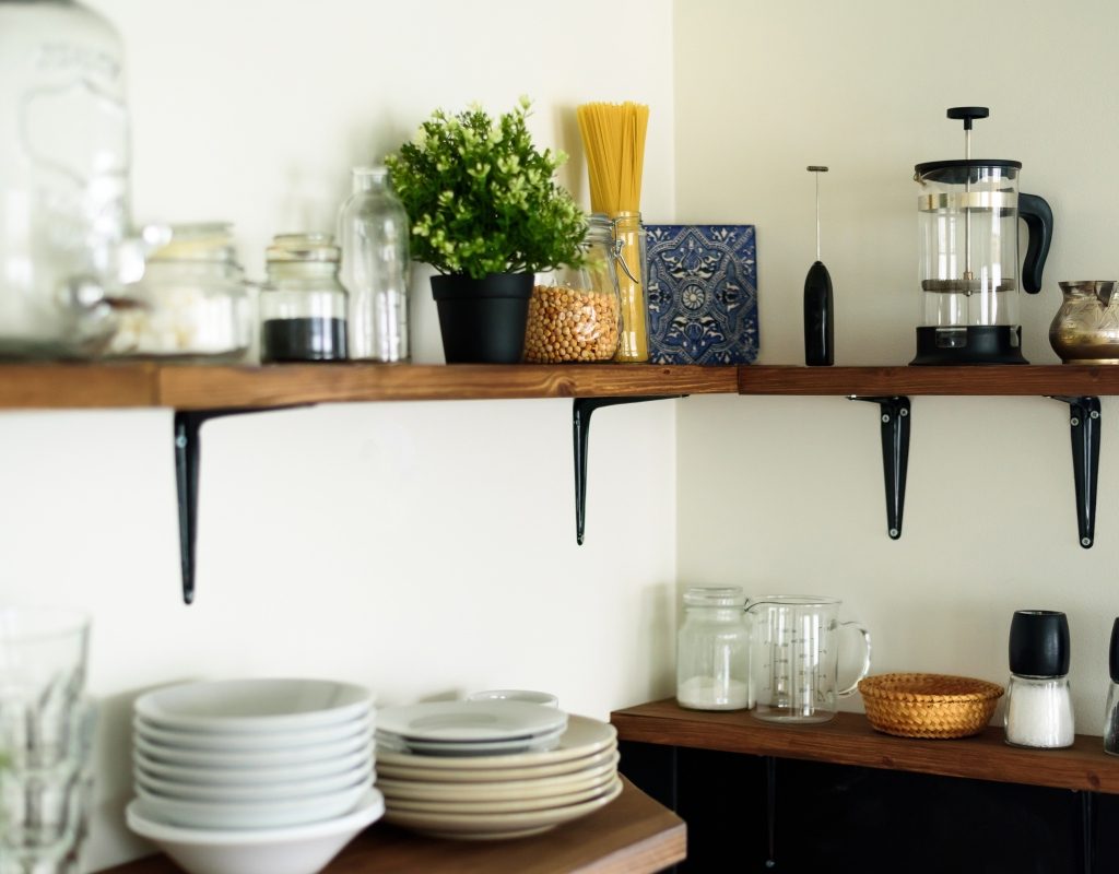 open shelving with coffee maker and dishes in small kitchen